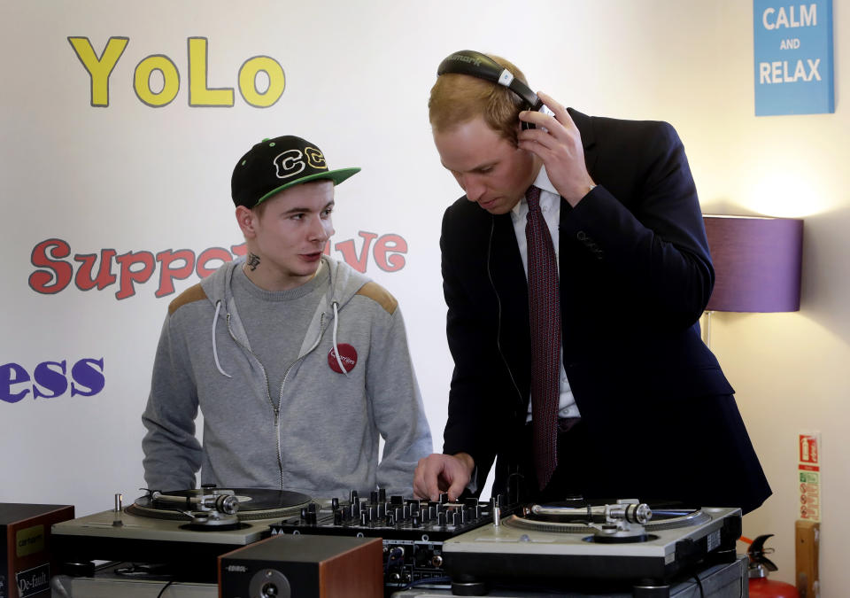 Britain's Prince William (R), Duke of Cambridge, uses a DJ set during a visit to the the Quarriers Stopover Project in Glasgow, Scotland on April 4, 2013. The Duke and Duchess of Cambridge, known as the Earl and Countess of Strathearn in Scotland,  visted the  Quarriers Stopover, which is a short-term residential unit for 14 young people aged between 16 and 25 who find themselves homeless.  AFP PHOTO / POOL / DANNY LAWSON        (Photo credit should read DANNY LAWSON/AFP via Getty Images)