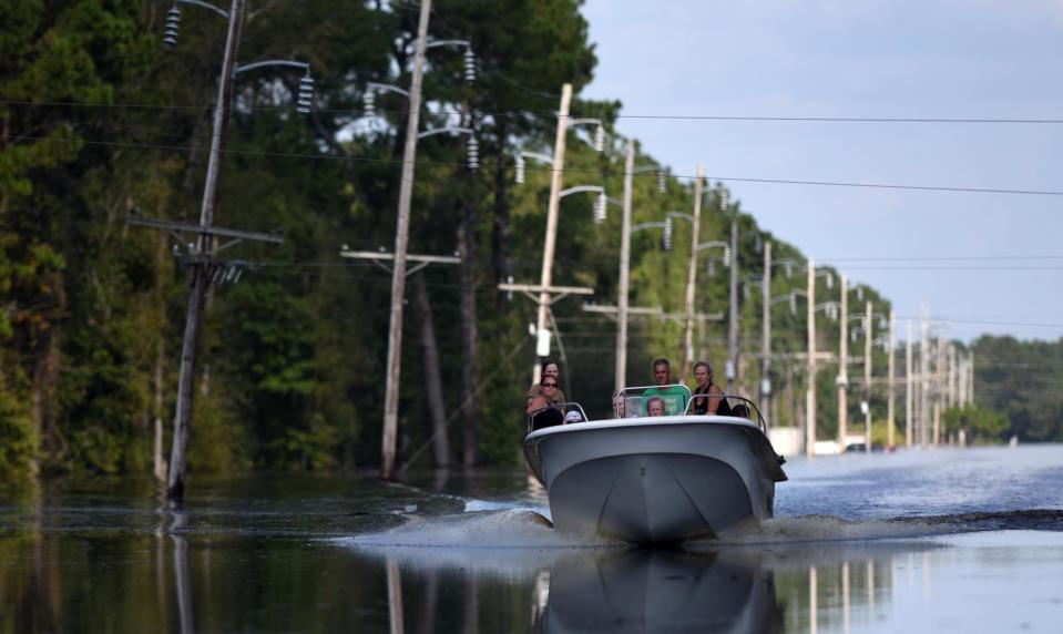 Hurricane Florence dropped record-setting amounts of rain across much of Eastern North Carolina when it hit the region in September 2018. Here, residents boat down a very flooded N.C. 53 near Burgaw.