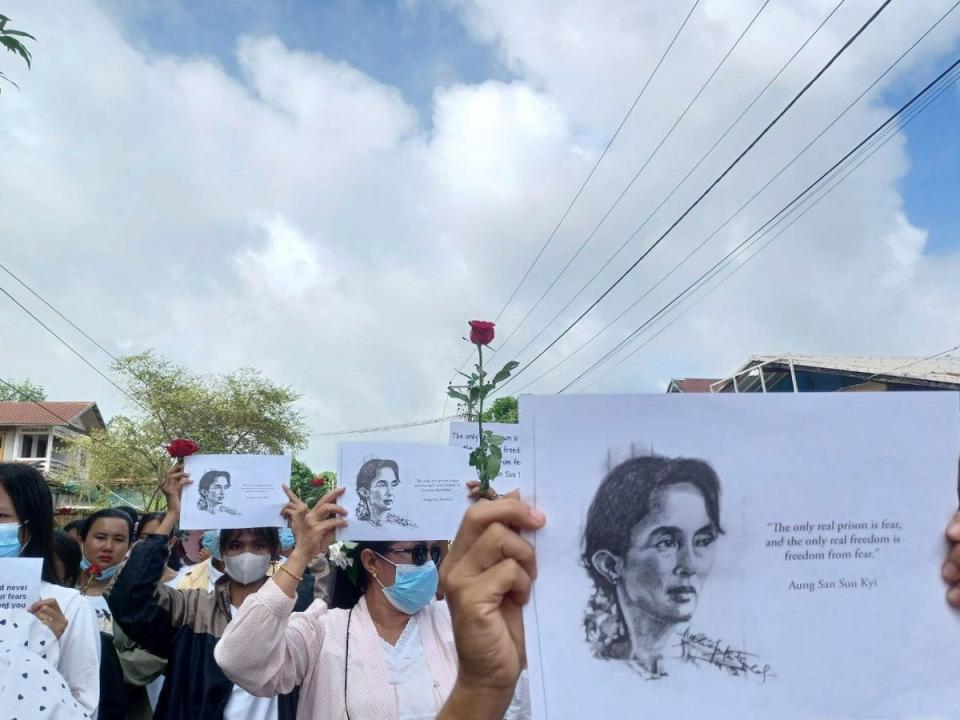 Demonstrators hold papers printed with Aung San Suu Kyi’s famous quote ‘The only real prison is fear, and the only real freedom is freedom from fear’ as they rally to mark her 79th birthday in Launglon township in Tanintharyi region, Myanmar (AP)