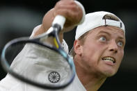 Tim van Rijthoven of the Netherlands serves to Serbia's Novak Djokovic during a men's fourth round singles match on day seven of the Wimbledon tennis championships in London, Sunday, July 3, 2022.(AP Photo/Kirsty Wigglesworth)