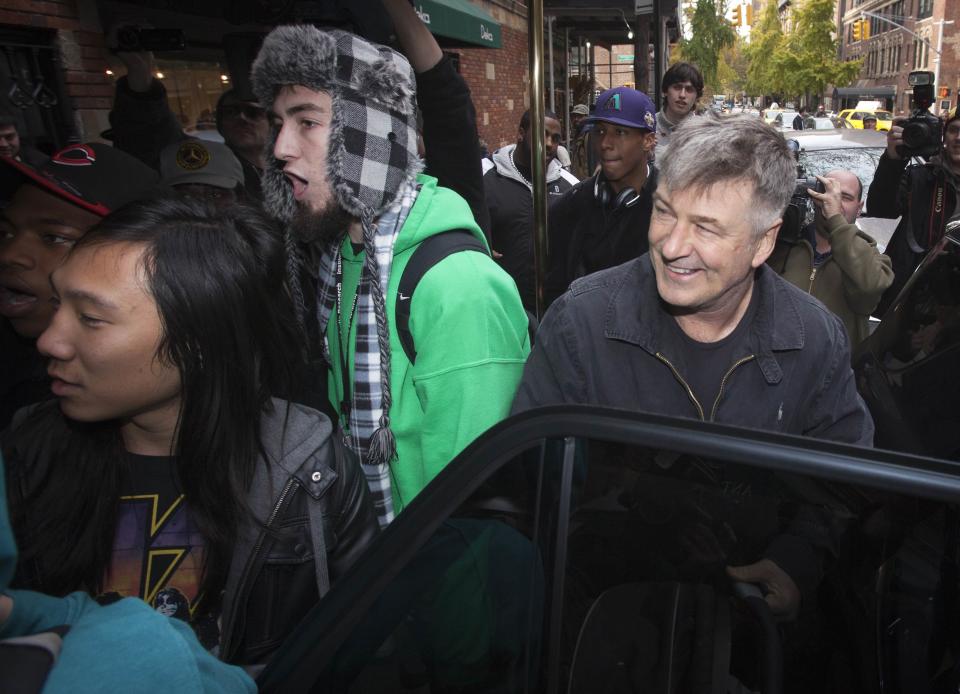 Actor Alec Baldwin laughs during a verbal altercation between people he had asked to block the media from taking photos and photographers, outside of his apartment in New York