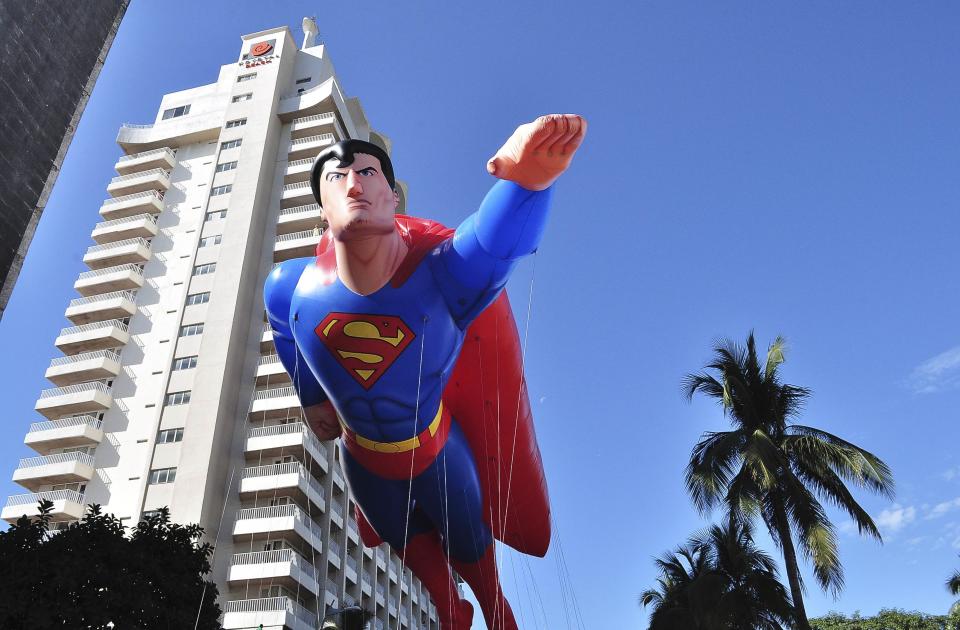 A balloon in the shape of comic hero Superman floats during a Christmas parade along the waterfront of Acapulco