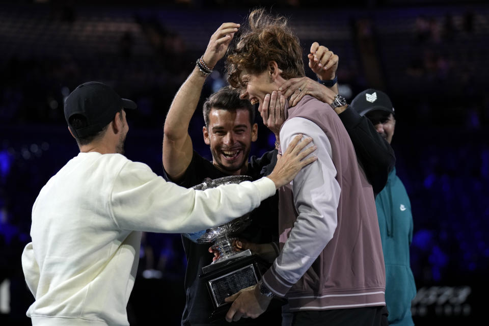 Jannik Sinner of Italy is congratulated by his support team after receiving the Norman Brookes Challenge Cup after defeating Daniil Medvedev of Russia in the men's singles final at the Australian Open tennis championships at Melbourne Park, in Melbourne, Australia, Sunday, Jan. 28, 2024. (AP Photo/Andy Wong)