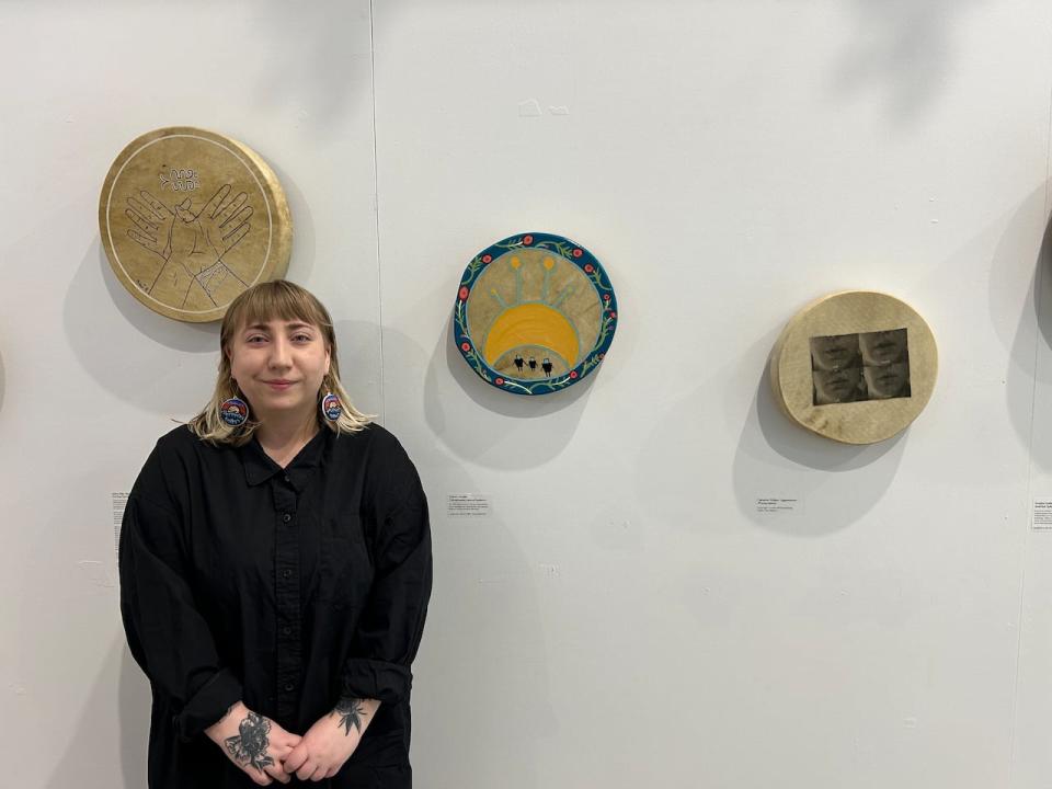 Artist Sydney Wreaks is pictured here with her drum 'Onkwehonwe Lakoterihwaien:ni' (middle drum). The title means 'human beings responsibility' in Kanien'kéha kateweiénhstha, and represents the relationship and responsibility as human beings to the land. 