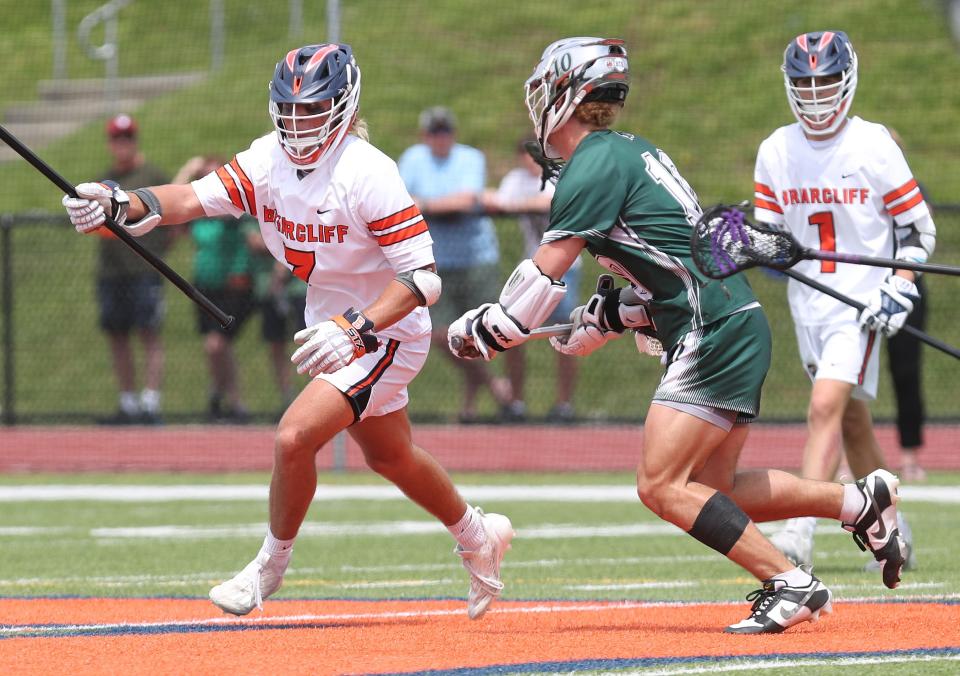 Briarcliff's Luca Meola (7) tries to get around Pleasantville's Daniel Picart (10) during boys lacrosse action at Briarcliff High School  May 13, 2023. 