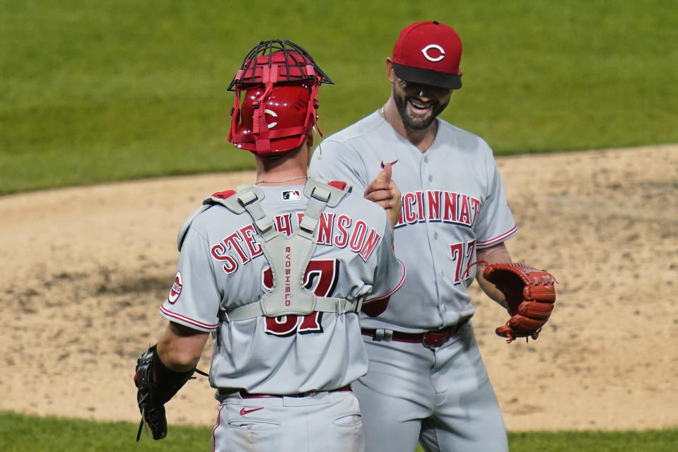 Cincinnati Reds relief pitcher Art Warren, right, shakes hands with catcher Tyler Stephenson after the team's 4-0 win over the Pittsburgh Pirates in a baseball game Thursday, May 12, 2022, in Pittsburgh. (AP Photo/Keith Srakocic)