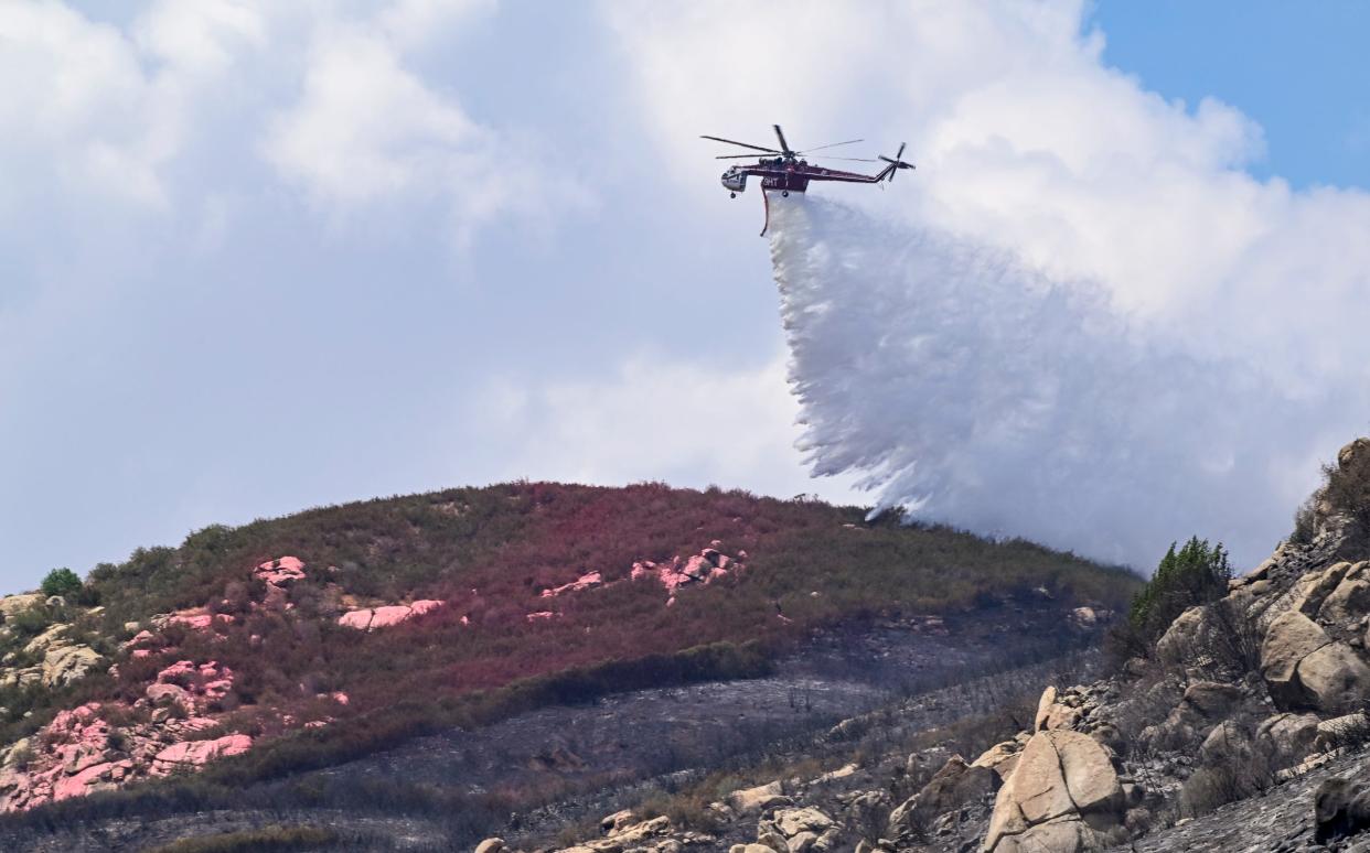  A helicopter dumps water Wednesday, August 17 to help ground crews on the Wishon fire near the Tule River Powerhouse.