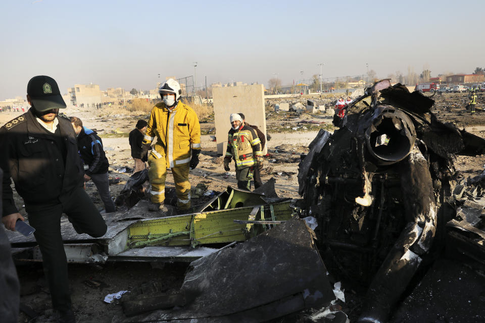 Debris is seen from an Ukrainian plane which crashed as authorities work at the scene in Shahedshahr southwest of the capital Tehran, Iran, Wednesday, Jan. 8, 2020. (Photo: Ebrahim Noroozi/AP)