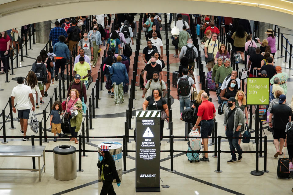 Passengers enter a security checkpoint before their flights at Hartsfield-Jackson Atlanta International Airport ahead of the Fourth of July holiday in Atlanta, Georgia, U.S., July 1, 2022.  REUTERS/Elijah Nouvelage