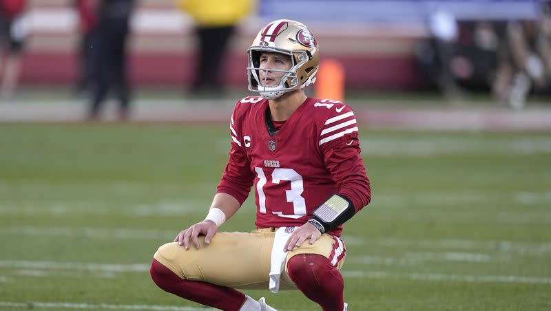 San Francisco 49ers quarterback Brock Purdy (13) crouches down on the field during the first half of the NFC championship game against the Detroit Lions in Santa Clara, Calif., Sunday, Jan. 28, 2024.