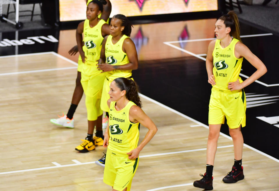 From left: Jewell Loyd, Epiphanny Prince, Sue Bird, Breanna Stewart in yellow jerseys on the court. 