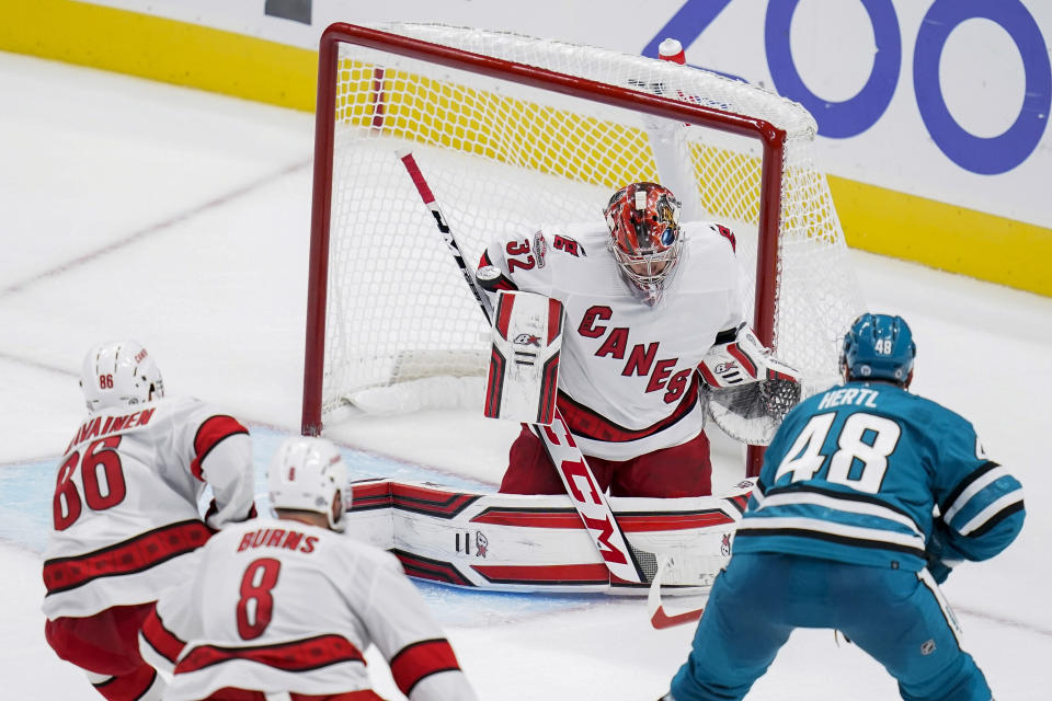 Carolina Hurricanes goaltender Antti Raanta (32) deflects a shot by San Jose Sharks center Tomas Hertl (48) during the third period of an NHL hockey game in San Jose, Calif., Friday, Oct. 14, 2022. (AP Photo/Godofredo A. Vásquez)