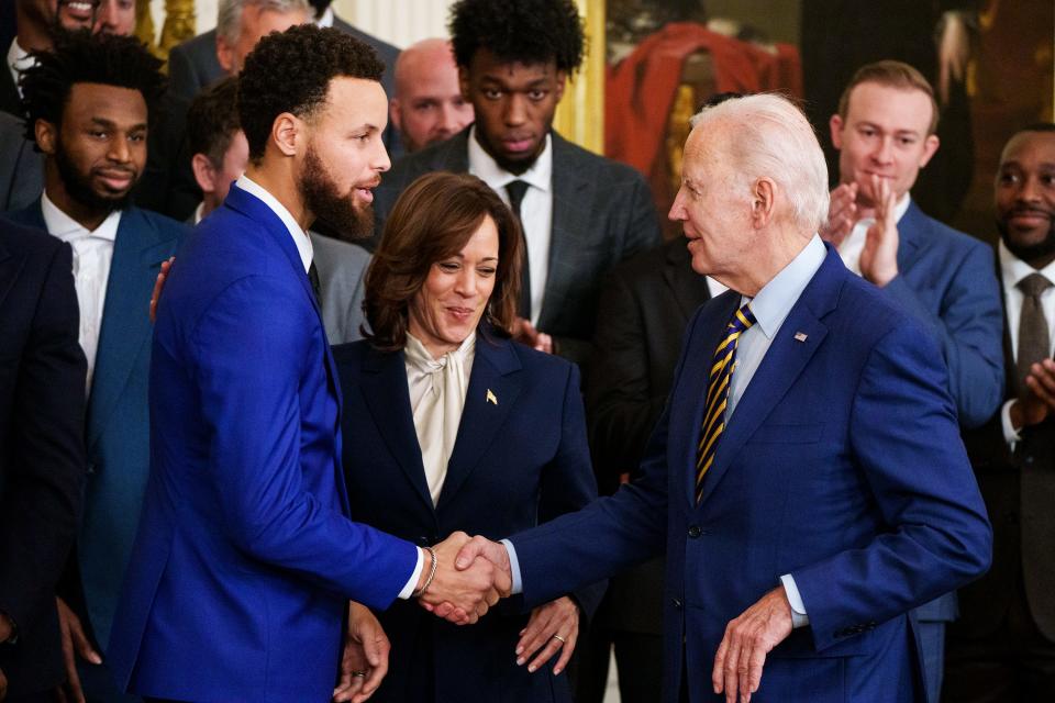 President Joe Biden, right, and Vice President Kamala Harris, center, welcomesSteph Curry and the Golden State Warriors to the East Room of the White House.