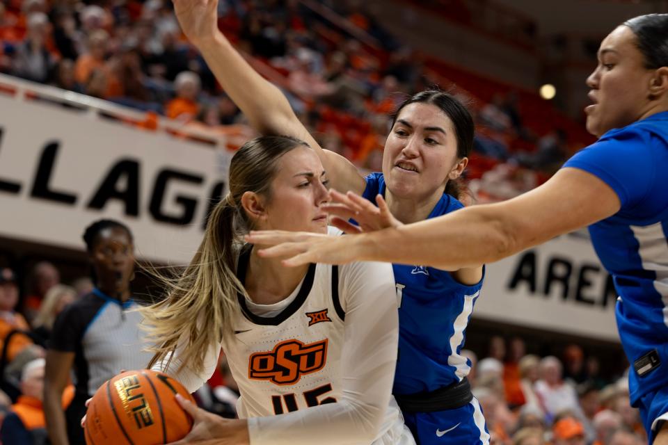 Jan 17, 2024; Stillwater, Okla, USA; BYU Cougars guard Kaylee Smiler, center, and BYU Cougars forward Ali'a Matavao, right, guard Oklahoma State Cowgirls guard Emilee Ebert, left, in the second half of a womenÕs NCAA basketball game at Gallagher Iba Arena. Mandatory Credit: Mitch Alcala-The Oklahoman