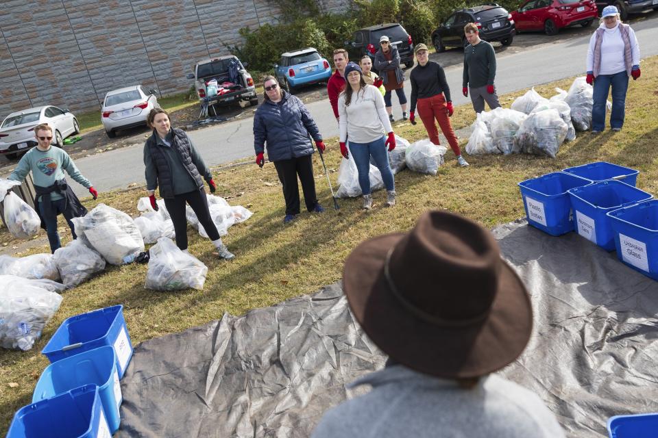 Volunteers wait for instructions from Riverkeeper leader Trey Sherard following a cleanup on Wednesday, Nov. 15, 2023, at Anacostia Park in Washington. For decades, the Anacostia was treated as a municipal dumping ground for industrial waste, storm sewers and trash. A sewer upgrade in the city and decades of local environmental advocacy have brought improvements to the river, but change has come slowly. (AP Photo/Tom Brenner)