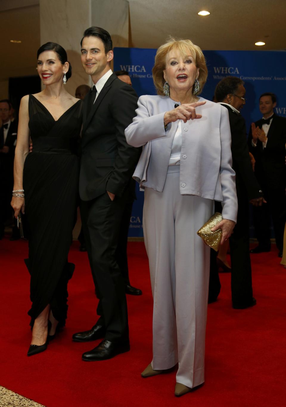 (L-R) Actress Julianna Margulies, her husband Keith Lieberthal and journalist Barbara Walters arrive on the red carpet at the annual White House Correspondents' Association Dinner in Washington, May 3, 2014. (REUTERS/Jonathan Ernst)