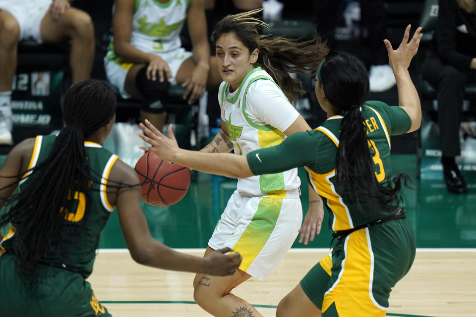 South Florida guard Maria Alvarez (1) drives around Baylor guard Trinity Oliver (3) and center Queen Egbo (25) during the second half of an NCAA women's college basketball game Tuesday, Dec. 1, 2020, in Tampa, Fla. (AP Photo/Chris O'Meara)