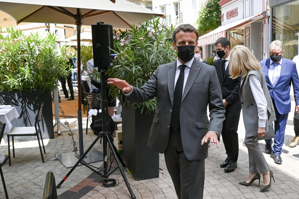 French President Emmanuel Macron arrives for a lunch Tuesday June 8, 2021 in Valence, southeastern France. French President Emmanuel Macron has been slapped in the face by a man during a visit in a small town of southeastern France, Macron's office confirmed. (Philippe Desmazes, Pool via AP)