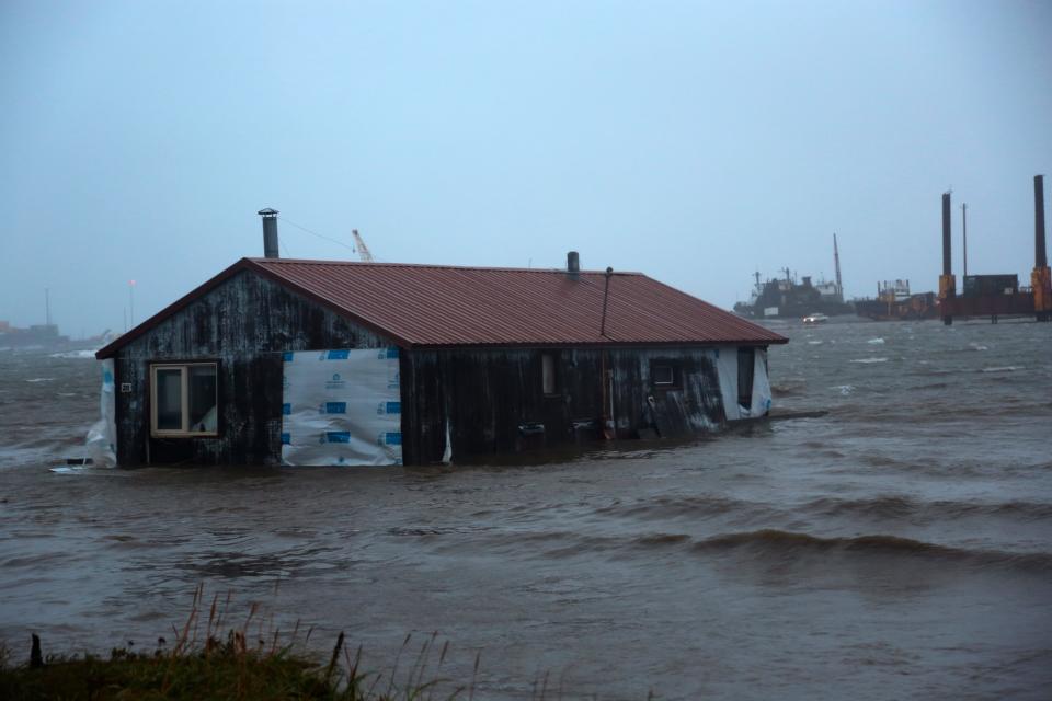 A home is seen floating in the Snake River near Nome, Alaska, on Saturday, Sept. 17, 2022. Much of Alaska's western coast could see flooding and high winds as the remnants of Typhoon Merbok moved into the Bering Sea region. The National Weather Service says some locations could experience the worst coastal flooding in 50 years.