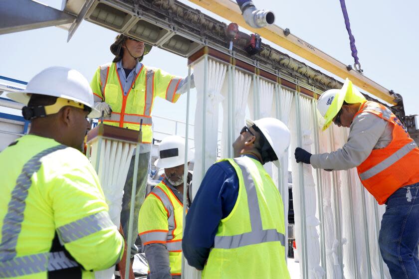 LOS ANGELES-CA-JUNE 30, 2022: Workers install membrane bioreactors at Metropolitan Water District's pilot water recycling facility in Carson is photographed on Thursday, June 30, 2022. (Christina House / Los Angeles Times)