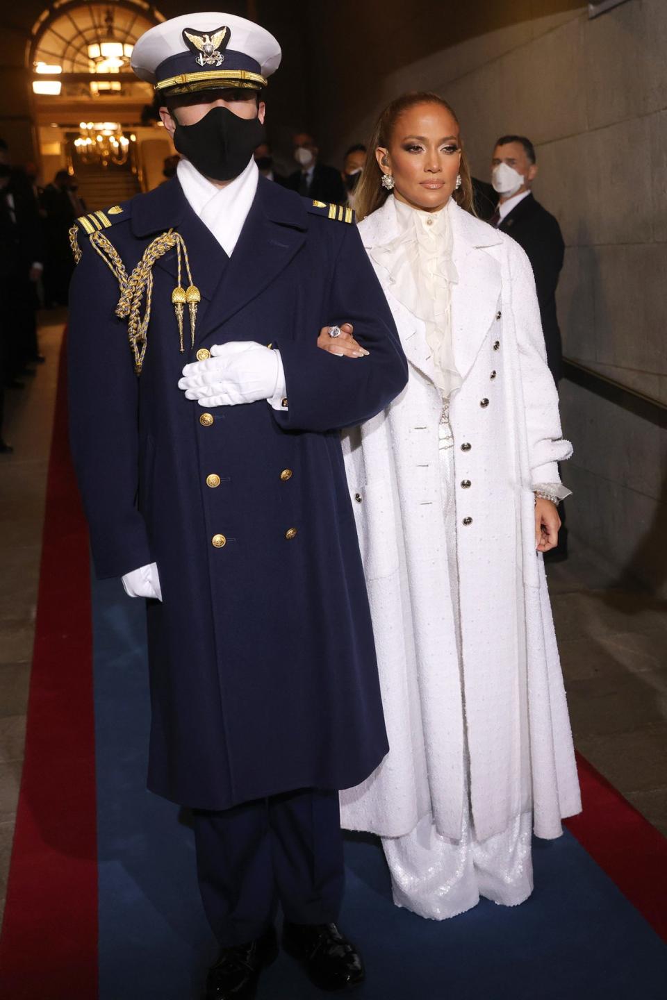 <p> Jennifer Lopez wears suffragette white as she is escorted to the inauguration. </p>