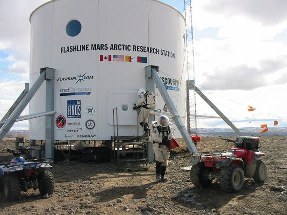 Situated at 75 degrees north, roughly 900 miles from the North Pole, Flashline Mars Arctic Research Station is located adjacent to a 20 kilometer meteor impact crater in the midst of a polar desert that is known to represent one of the most Mar