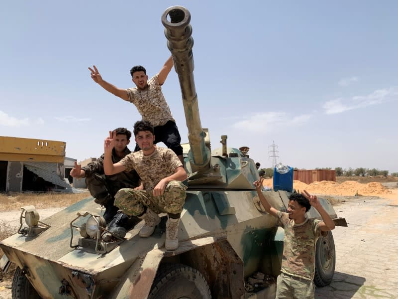 Fighters loyal to Libya's internationally recognised government celebrate after regaining control over Tripoli