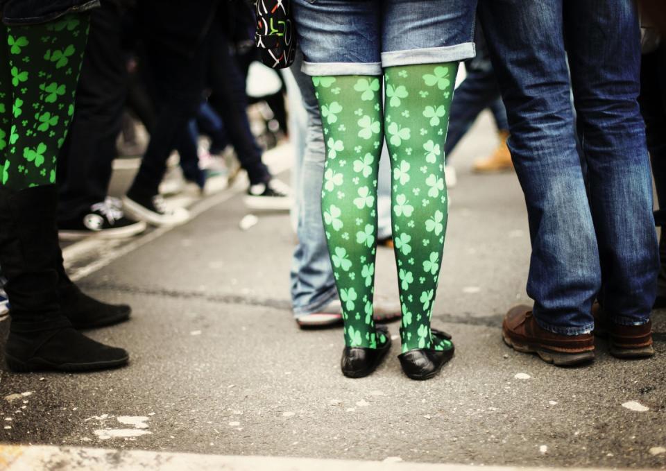 st patricks day parade photo focusing on woman's green clover patterned tights paired with denim cutoffs you might caption going green today