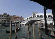 FILE - In this file photo dated Tuesday, March 27, 2018, a view of the Rialto bridge, in Venice, Italy. The recent devastating Notre Dame fire in Paris was a warning bell that all of Europe needs to hear, since so many monuments and palaces across the continent are in need of better upkeep according to European officials. National governments are increasingly looking for private donors to renovate major monuments prompting Diesel brand to back improvements for the Rialto bridge in Venice. (AP Photo/Luca Bruno)