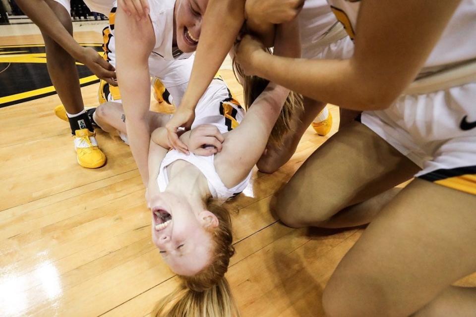 Missouri's Lauren Hansen is mobbed by teammates after hitting a game-winning layup in overtime to defeat No. 1 South Carolina on Thursday night at Mizzou Arena.