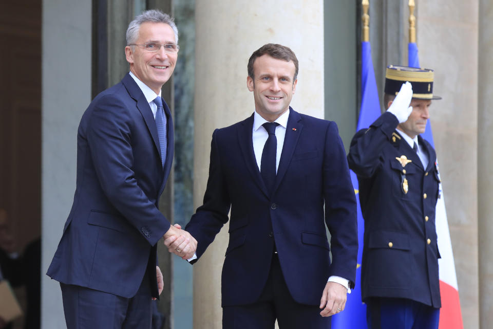 NATO Secretary General Jens Stoltenberg, left is welcomed by French President Emmanuel Macron at the Elysee Palace in Paris, Thursday, Nov. 28, 2019. NATO chief Jens Stoltenberg is to meet in Paris with French President Emmanuel Macron, whose recent public statement that it is "brain dead" has shaken the military alliance. (AP Photo/Michel Euler)