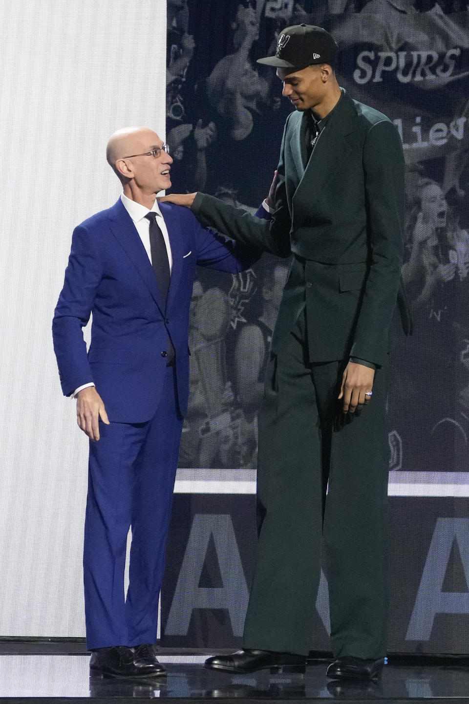 Victor Wembanyama is greeted by NBA commissioner Adam Silver after being selected first overall by the San Antonio Spurs during the NBA basketball draft, Thursday, June 22, 2023, in New York. (AP Photo/John Minchillo)