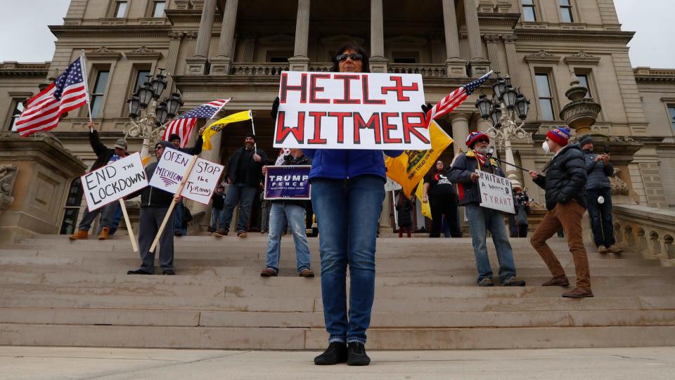 Demonstrators protesting Michigan Gov. Gretchen Whitmer's stay-at-home order outside the Capitol building in Lansing, April 15, 2020.