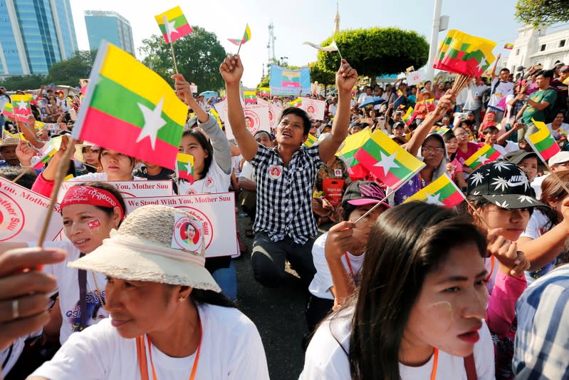 People gather to rally in support of Myanmar State Counsellor Aung San Suu Kyi before she heads off to the International Court of Justice (ICJ), in Yangon