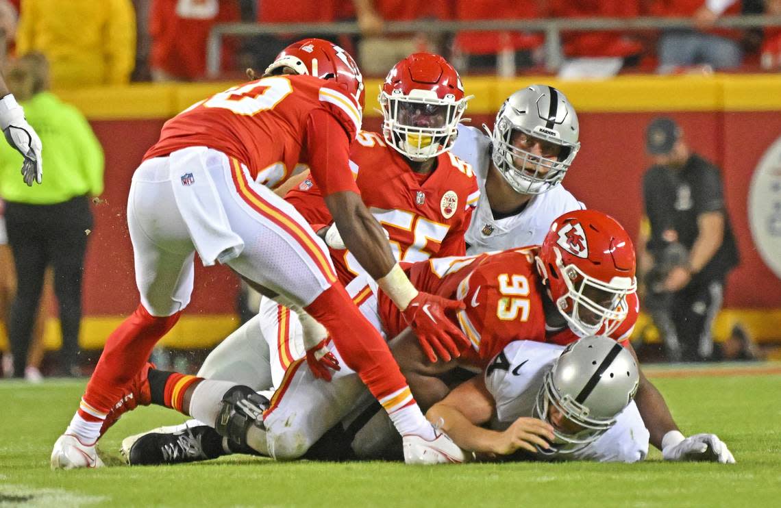 Kansas City Chiefs defensive tackle Chris Jones (95) sacks Las Vegas Raiders quarterback Derek Carr (4) during an NFL football game Monday.