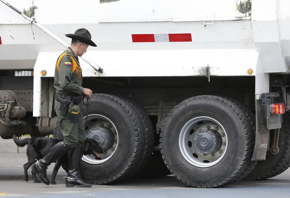 Police inspect a truck outside the General Francisco de Paula Santander Police Academy a day after a car bomb exploded at the site, in Bogota, Colombia, Friday, Jan. 18, 2019. Colombia blames the National Liberation Army, ELN, rebels for the deadly attack that left more than 20 dead and wounded many others. (AP Photo/John Wilson Vizcaino)