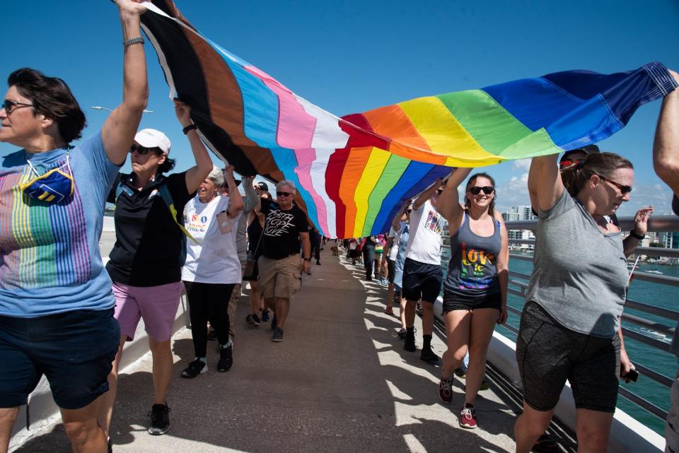 Hundreds of LGBTQ residents and their supporters rallied and waved a 700-foot LGBTQ pride flag over the Ringling Bridge in Sarasota Sunday in opposition to Florida's 'Don't Say Gay' bill.