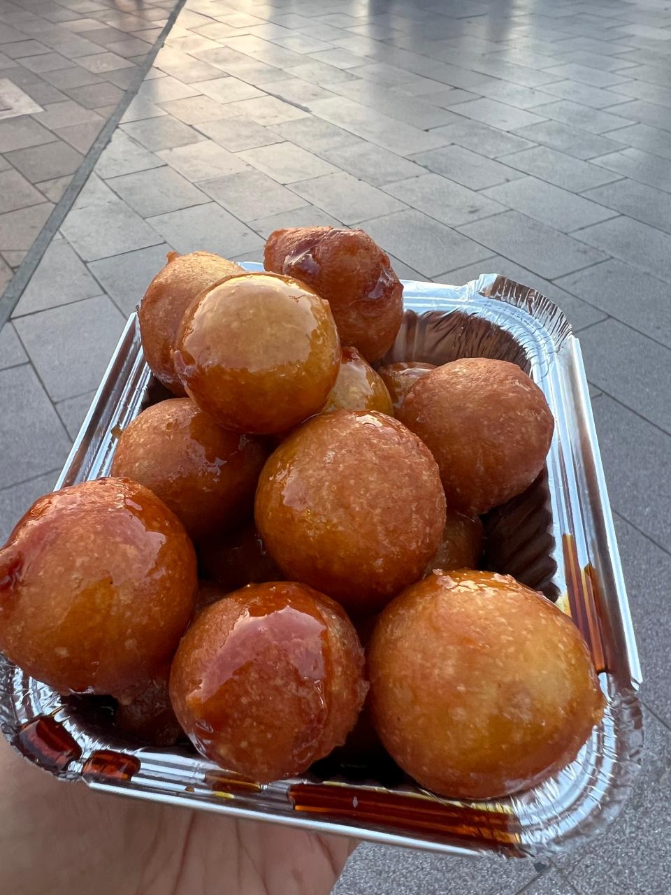 Luqaimat is a deep-fried dough covered with data syrup.