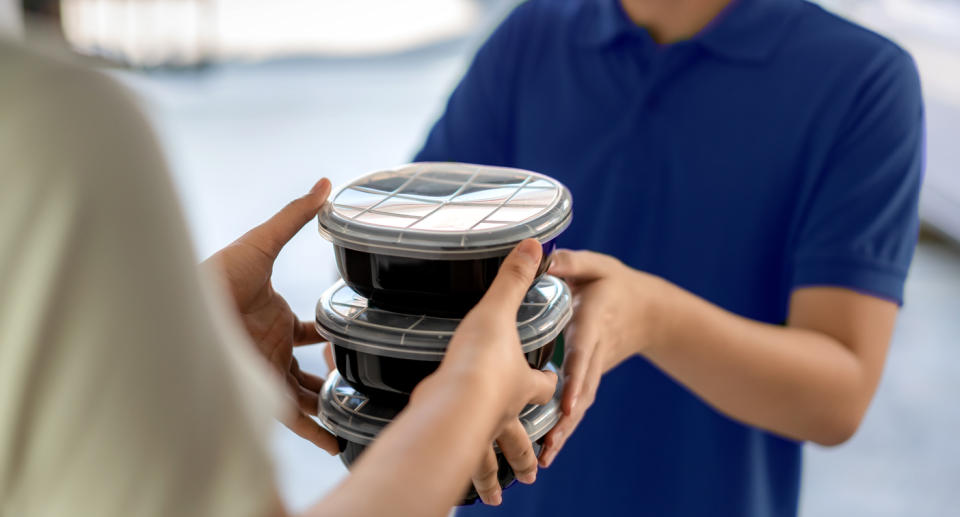 Stock image of food being handed over.