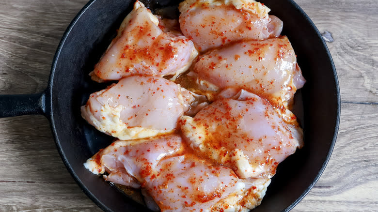 raw chicken thighs in pan