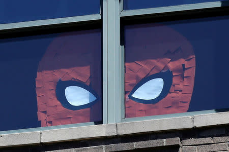 An image of Spider Man created with Post-it notes is seen in windows at 200 Hudson street in lower Manhattan, New York, May 18, 2016. REUTERS/Mike Segar