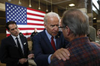 Democratic presidential candidate former Vice President Joe Biden, center, talks with a local resident during a community event, Wednesday, Oct. 16, 2019, in Davenport, Iowa. (AP Photo/Charlie Neibergall)