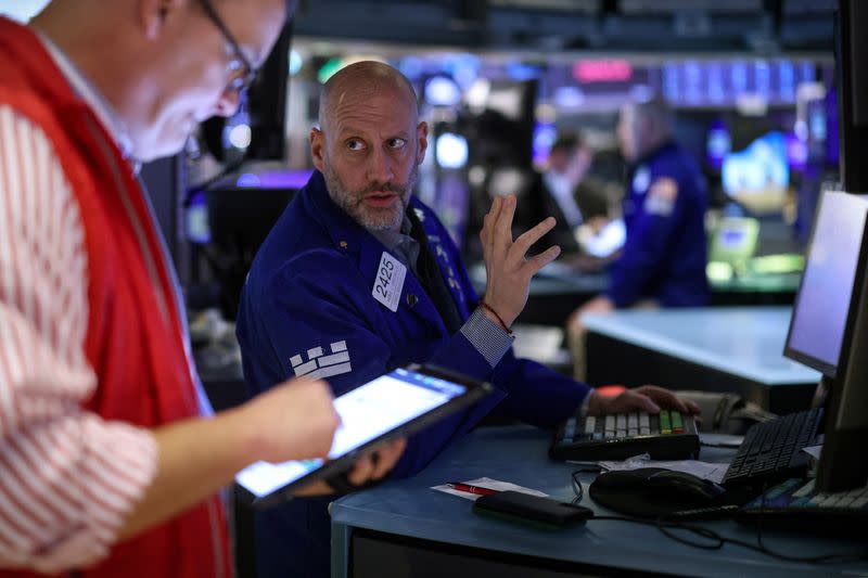 Traders work on the floor of the NYSE in New York