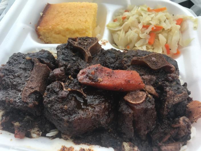 Oxtail with white rice, cabbage and cornbread can be found on the menu at Sir B Jamaican Food Bar-B-Q Grill, north of Vero Beach.