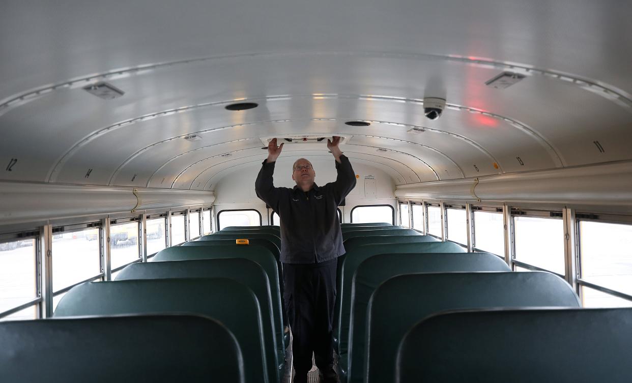 David O'Bryan, whose full-time job for Westerville City Schools is mechanic, performs safety checks prior to driving a route Jan. 14. O'Bryan is among several district employees who are doing multiple jobs at a time when school districts are struggling with staffing shortages.