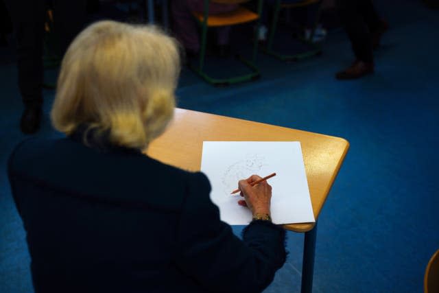 The Queen Consort drawing the Gruffalo, during a visit to Rudolf Ross Grundschule School, Hamburg