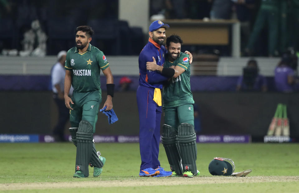 Indian cricket captain Virat Kohli, centre, congratulates Pakistan's Mohammad Rizwan after Pakistan won the Cricket Twenty20 World Cup match between India and Pakistan in Dubai, UAE, Sunday, Oct. 24, 2021. (AP Photo/Aijaz Rahi)