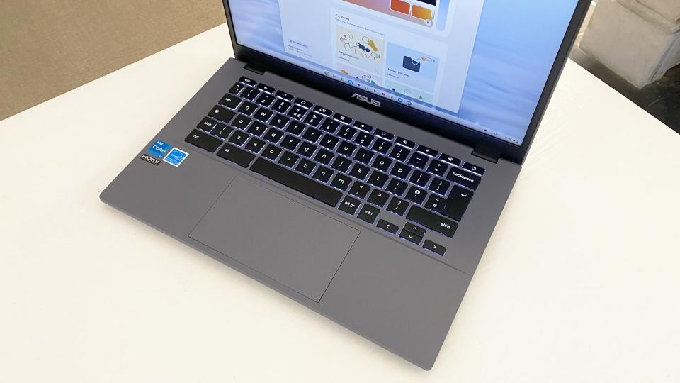 Asus Chromebook Plus laptop open with the screen on, sitting on a desk