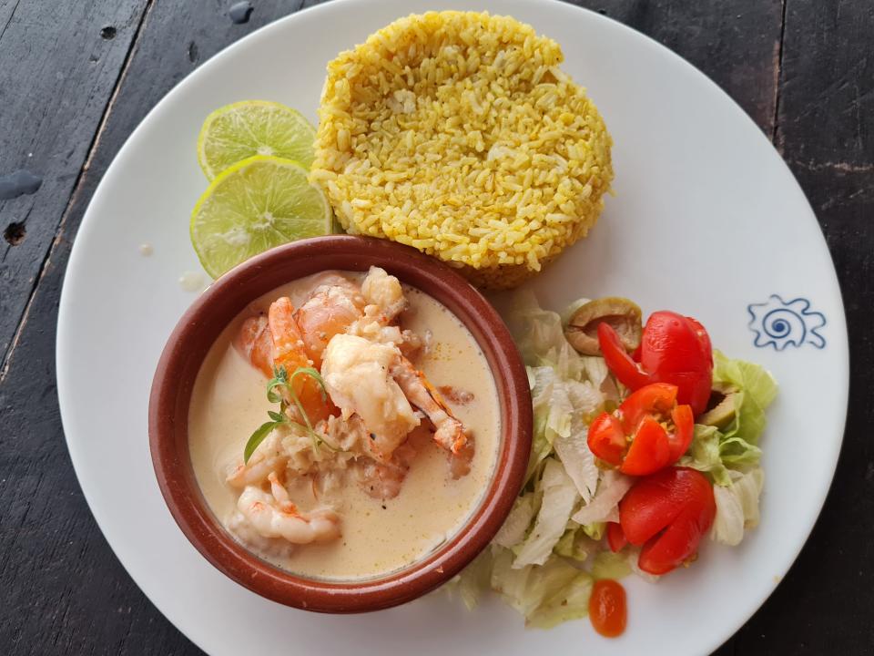 plate of rice, shrimp, ad a small salad