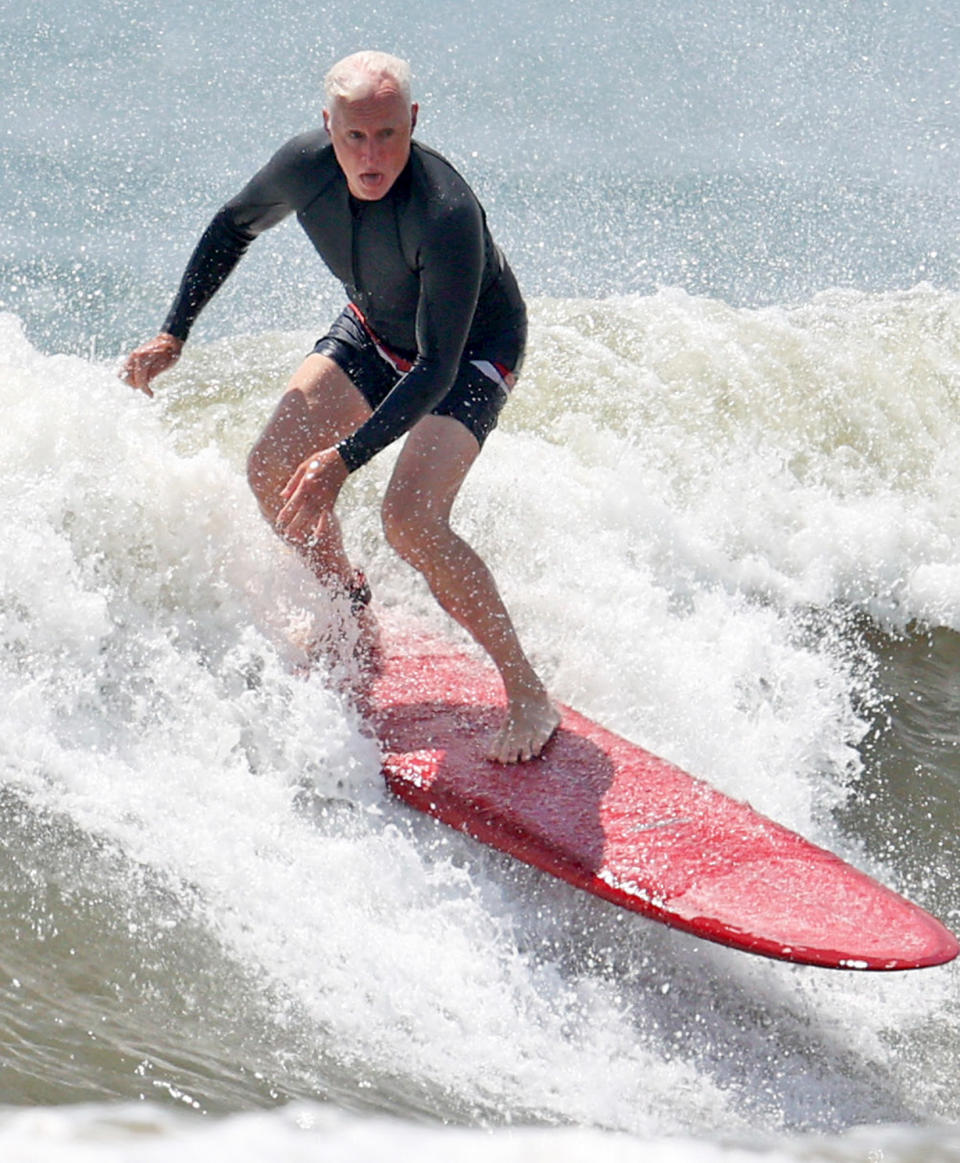 <p>John Slattery catches a wave in The Hamptons, New York, on July 6.</p>